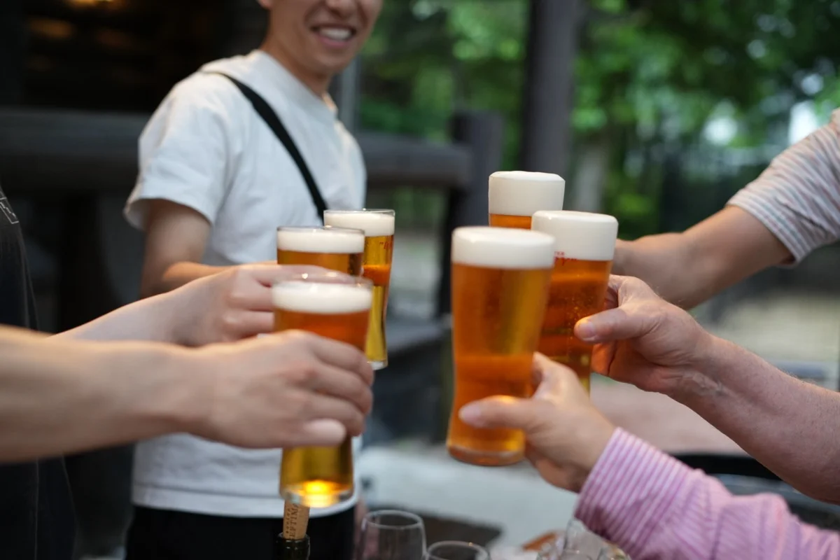 People raising mugs of draft beer